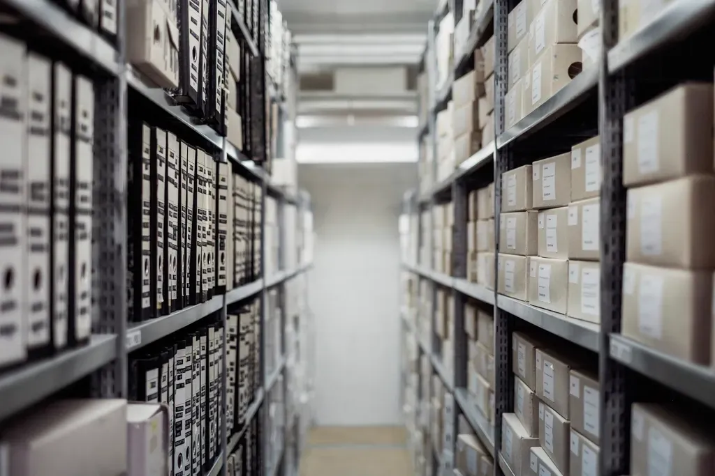Warehouse aisle with shelves of cardboard boxes