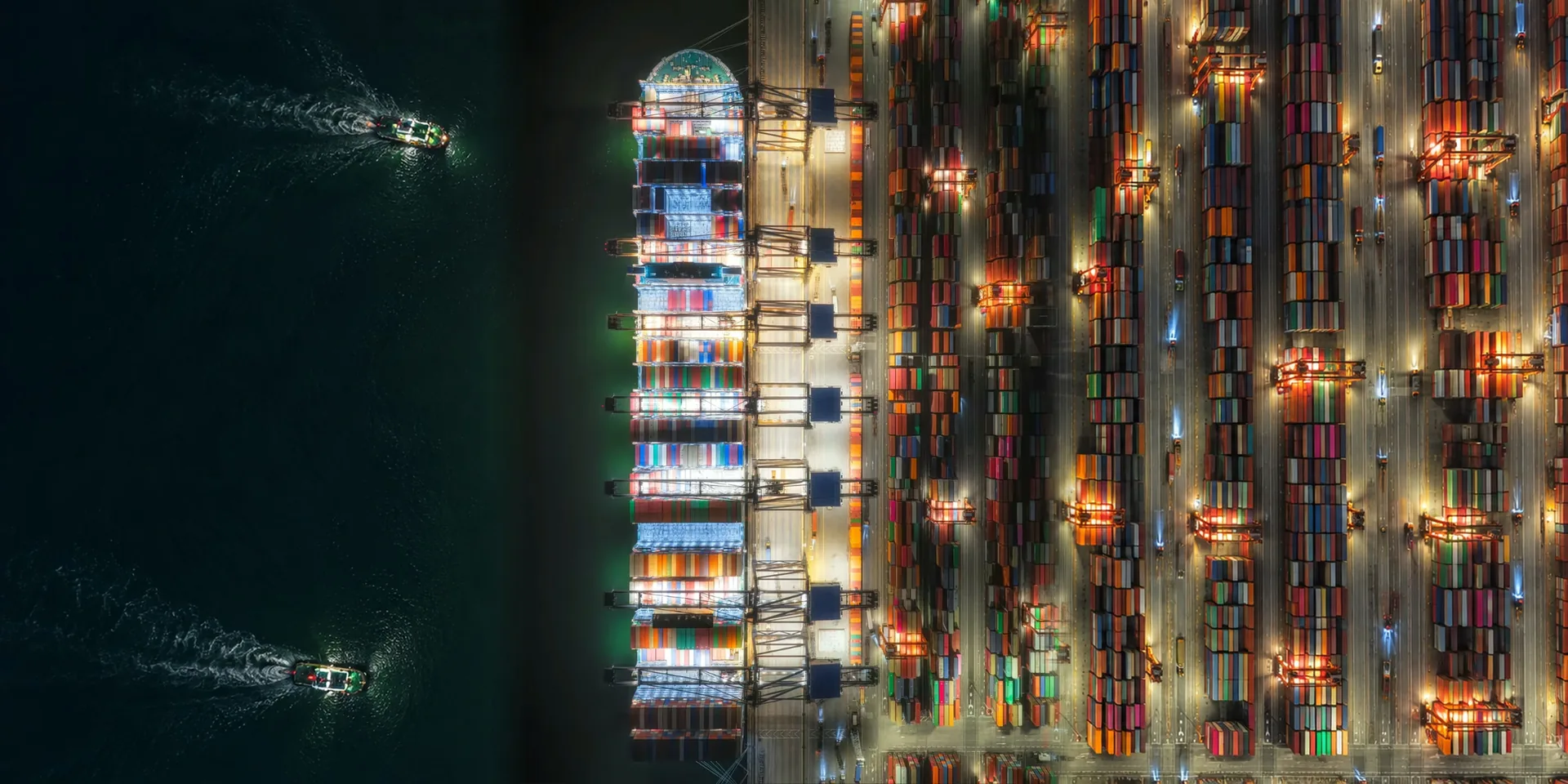 A container terminal at night, lit from above