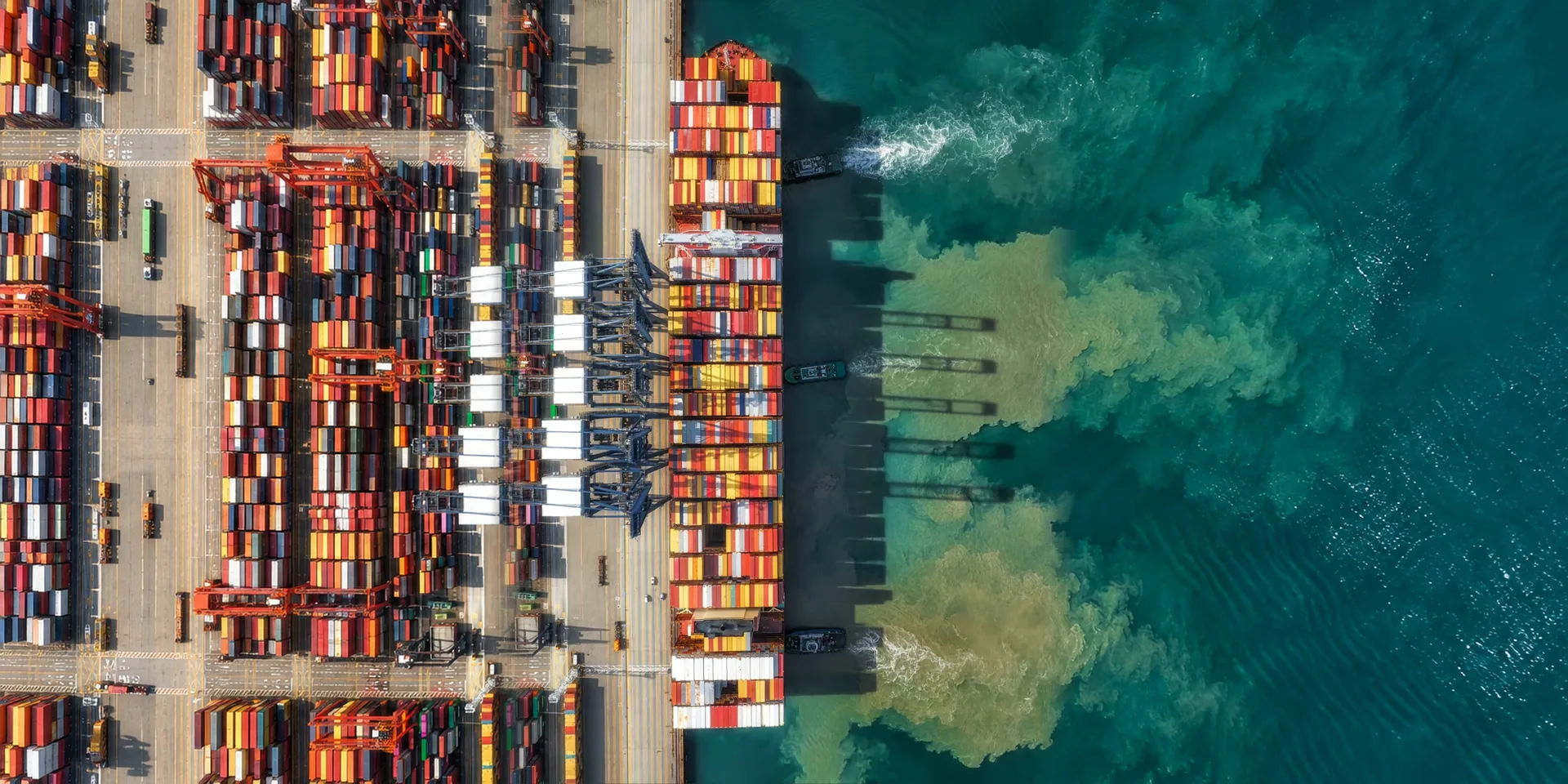 A ship at a quay with the container stacks behind it