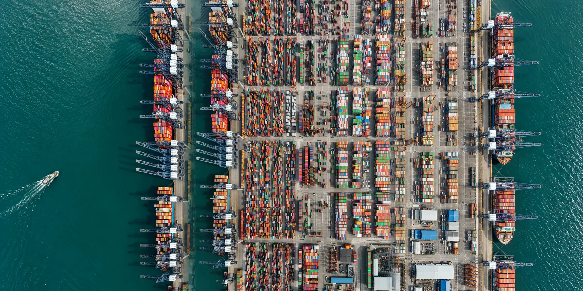 A port yard split by water, seen from above